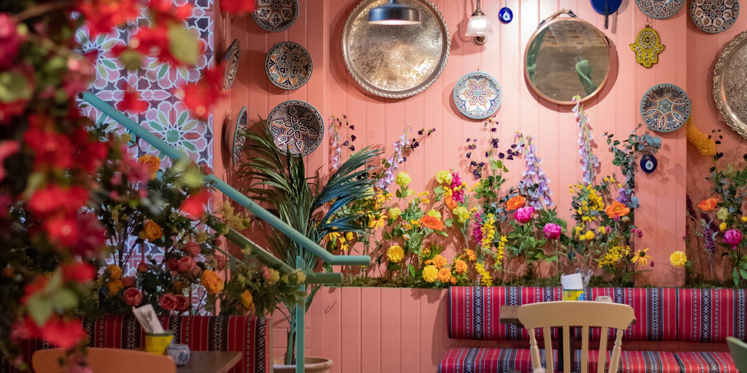 wall full of decorative plates and flowers in traditional middle eastern restaurant