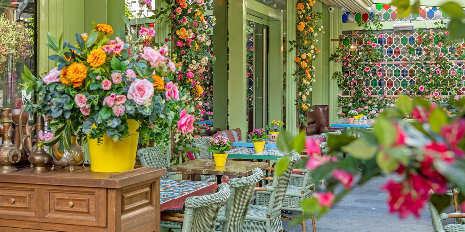 green tables and walls with colourful flowers