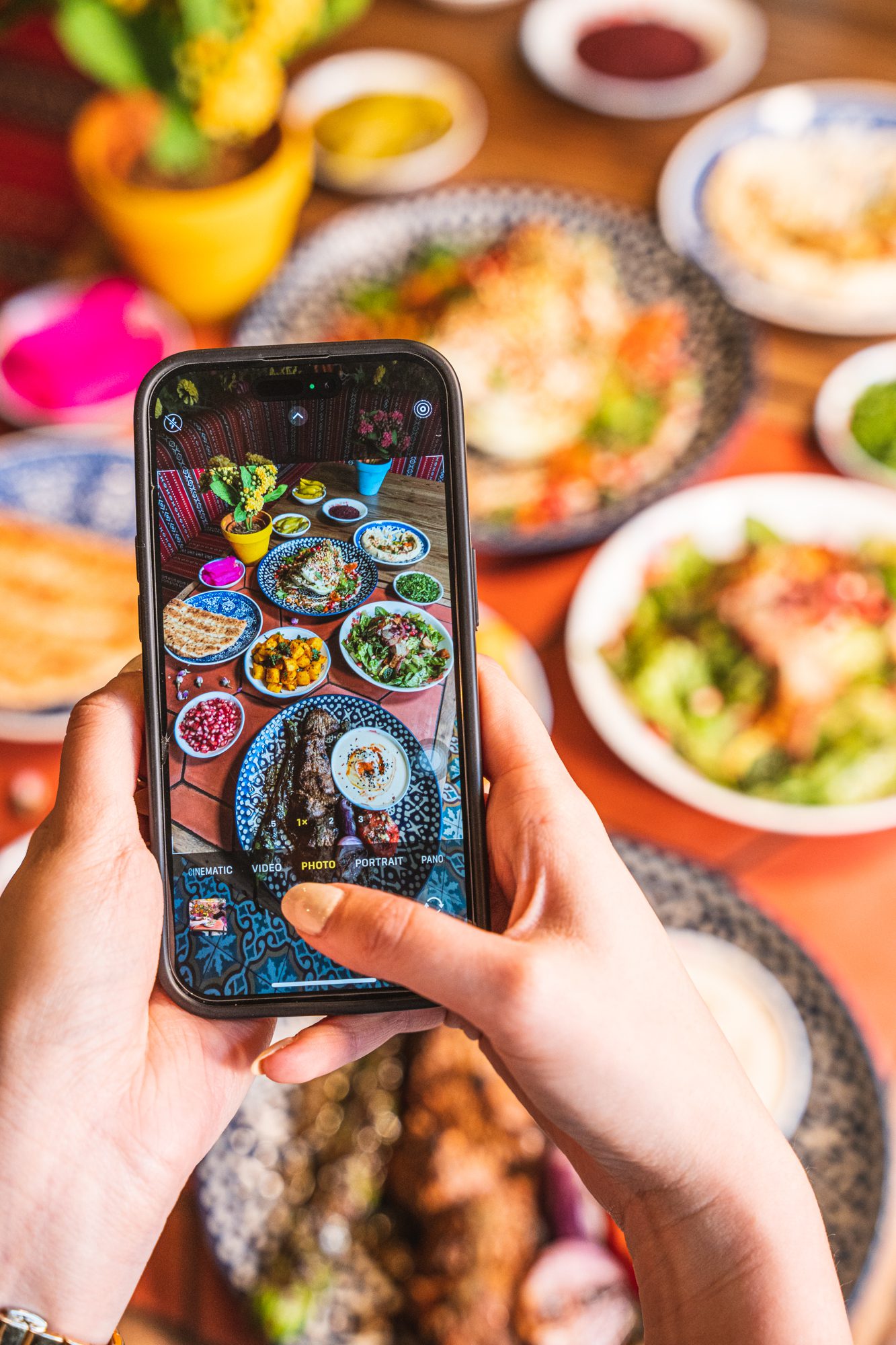 phone taking photo of lebanese dishes